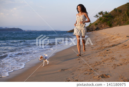 Woman, running on beach and dog with travel for ocean, vacation in Cancun and nature with pet. Fresh air, wellness and energy with puppy outdoor, happiness for adventure and tourism on island Woman, running on beach and dog with travel for ocean, vacation in Cancun and nature with pet. Fresh air, wellness and energy with puppy outdoor, happiness for adventure and tourism on island 141180975
