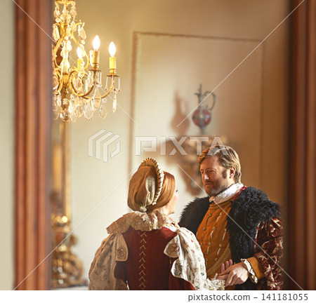 Victorian, man and woman talking in royal castle together with vintage love, romance and banquet hall. Medieval king, queen or renaissance couple in ballroom holding hands with conversation in palace Victorian, man and woman talking in royal castle together with vintage love, romance and banquet hall. Medieval king, queen or renaissance couple in ballroom holding hands with conversation in palace 141181055