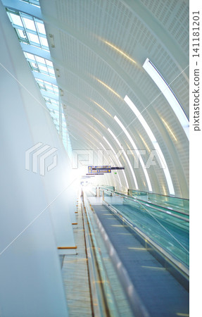 Airport, building and design with interior and window in futuristic architecture for travel, aircraft and flight. Modern urban and editorial with walls for movement, destination and travelers Airport, building and design with interior and window in futuristic architecture for travel, aircraft and flight. Modern urban and editorial with walls for movement, destination and travelers 141181201