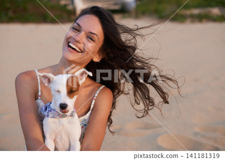 Woman, portrait and dog on beach for happy holiday at sunset for vacation getaway, weekend or bonding. Female person, Jack Russell and face in summer for morning rest in Florida, calm or relaxing Woman, portrait and dog on beach for happy holiday at sunset for vacation getaway, weekend or bonding. Female person, Jack Russell and face in summer for morning rest in Florida, calm or relaxing 141181319