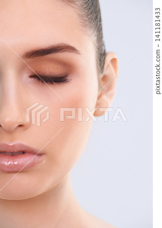 Beauty, skincare and half face of woman with eyes closed, relax and benefits of cosmetics in studio. Dermatology, health and girl with natural makeup, glow and luxury skin care on white background Beauty, skincare and half face of woman with eyes closed, relax and benefits of cosmetics in studio. Dermatology, health and girl with natural makeup, glow and luxury skin care on white background 141181433