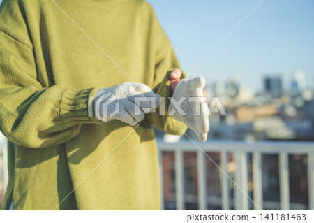A woman holding a glove A woman holding a glove 141181463