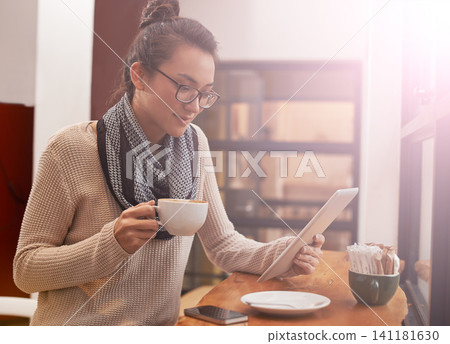 Woman, coffee shop and tablet with freelancer research and social media in cafe with cappuccino. Website, drink and internet with digital blog writer and technology at restaurant with tea and reading Woman, coffee shop and tablet with freelancer research and social media in cafe with cappuccino. Website, drink and internet with digital blog writer and technology at restaurant with tea and reading 141181630