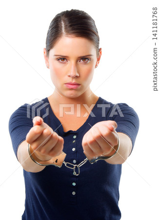 Woman, portrait and handcuffs in studio for arrest of prisoner for justice of law and crime. Criminal or thief, serious for custody and restrained for jail for illegal counterfeiting in Venezuela 141181768