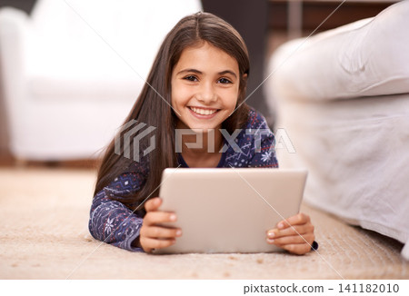 Floor, portrait or child with tablet for streaming, playing games or watching fun videos on movie website. Girl, house or happy kid with technology to download online or social media app to relax 141182010
