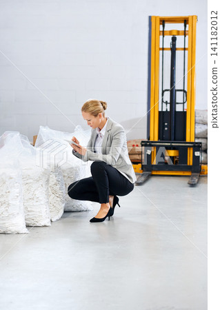 Factory, business woman and warehouse inspection of raw materials, notes and quality assurance of stock. Writing, planning and female inspector on site, stocktaking and decision on inventory on floor Factory, business woman and warehouse inspection of raw materials, notes and quality assurance of stock. Writing, planning and female inspector on site, stocktaking and decision on inventory on floor 141182012