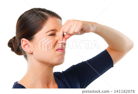Smelly, yuck and woman with disgust facial expression for gross, fart and odor on white background and alone. Young person or model and isolated with finger on nose for stink or scent on mockup Smelly, yuck and woman with disgust facial expression for gross, fart and odor on white background and alone. Young person or model and isolated with finger on nose for stink or scent on mockup 141182078