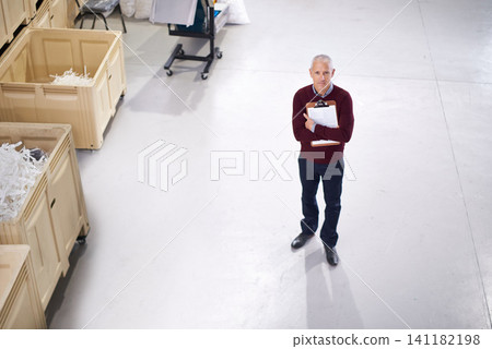 Top view, checklist or portrait of man in factory inspection for stock in a plant, supplier or production. Manufacturing, clipboard or manager on warehouse floor for plastic, logistics or resources Top view, checklist or portrait of man in factory inspection for stock in a plant, supplier or production. Manufacturing, clipboard or manager on warehouse floor for plastic, logistics or resources 141182198