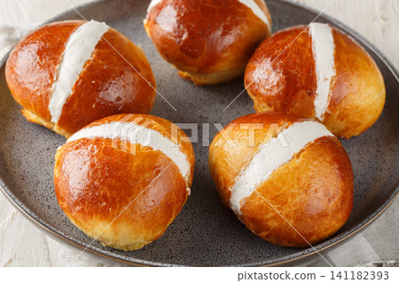 Maritozzi Italian sweet buns with cream close-up in a plate. Horizontal Maritozzi Italian sweet buns with cream close-up in a plate. Horizontal 141182393