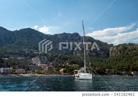 Luxury motor yacht sailing near rocky island in Marmaris Turkey Luxury motor yacht sailing near rocky island in Marmaris Turkey 141182461