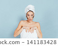 Woman with patches over eyes, towel on head 141183428