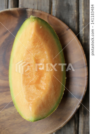 Cut, perfectly ripe, sweet and delicious Yubari melon (red-fleshed melon) Cut, perfectly ripe, sweet and delicious Yubari melon (red-fleshed melon) 141183484