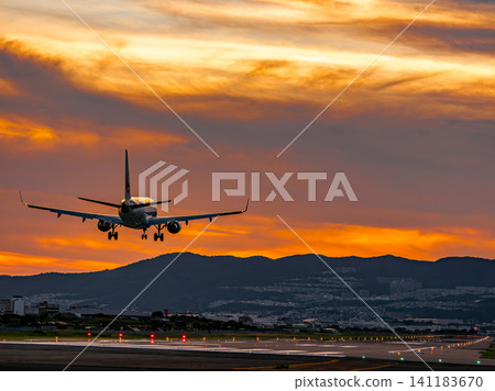 A plane landing at Itami Airport at dusk A plane landing at Itami Airport at dusk 141183670