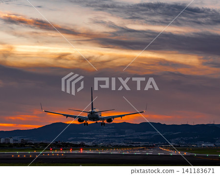 A plane landing at Itami Airport at dusk A plane landing at Itami Airport at dusk 141183671