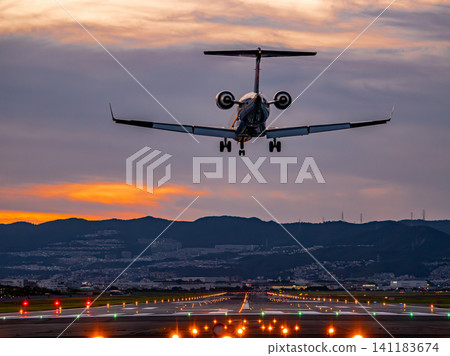 A plane landing at Itami Airport at dusk A plane landing at Itami Airport at dusk 141183674