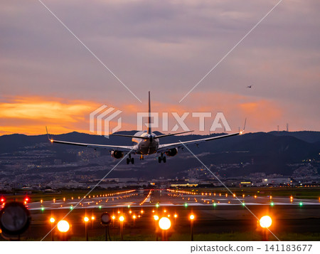 A plane landing at Itami Airport at dusk A plane landing at Itami Airport at dusk 141183677
