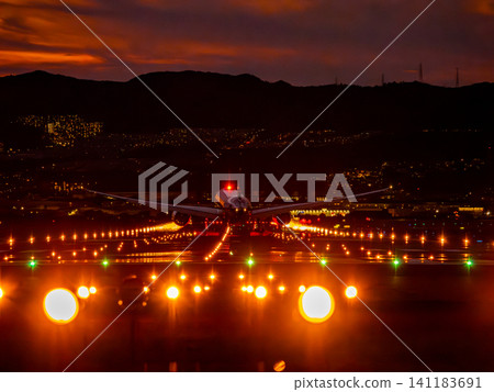 A plane landing at Itami Airport at dusk A plane landing at Itami Airport at dusk 141183691