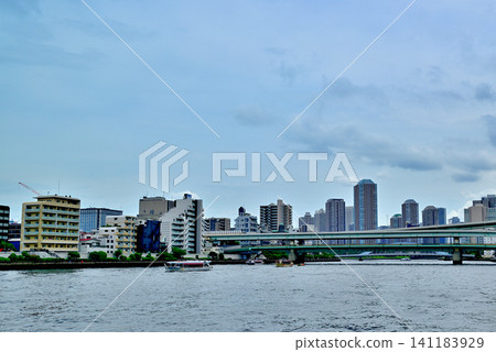 A view of the tower apartment buildings in Tsukuda, Chuo Ward, across the Sumida River Bridge from the Sumida River Terrace. A view of the tower apartment buildings in Tsukuda, Chuo Ward, across the Sumida River Bridge from the Sumida River Terrace. 141183929
