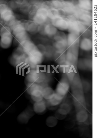 A monochrome background image featuring vertically arranged, organic, and delicate abstract bokeh. A monochrome background image featuring vertically arranged, organic, and delicate abstract bokeh. 141184622