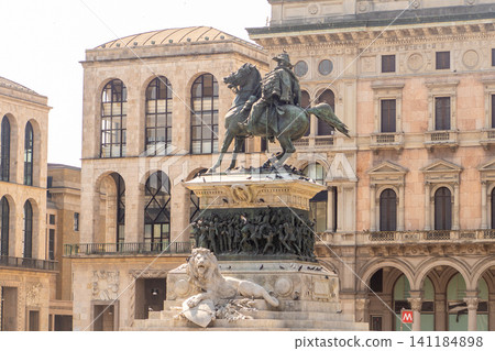 Equestrian Statue of Vittorio Emanuele II with a Stone Lion Sculpture in Front of Milan Buildings Equestrian Statue of Vittorio Emanuele II with a Stone Lion Sculpture in Front of Milan Buildings 141184898