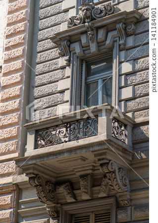 Classic Building Facade with Ornate Window and Stone Balcony with Wrought Iron Railing in Milan Classic Building Facade with Ornate Window and Stone Balcony with Wrought Iron Railing in Milan 141184901