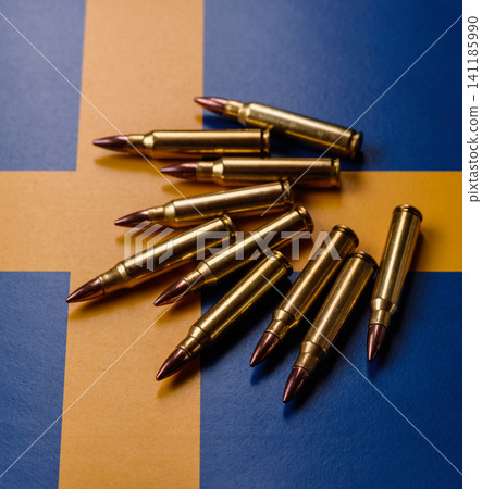 Assault rifle cartridges on the Sweden flag, serving as a conceptual backdrop 141185990