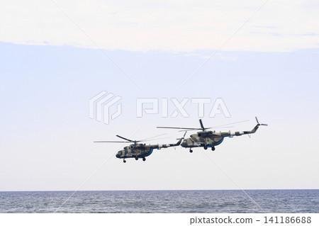 military helicopters flying over ocean, military helicopters flying over ocean, 141186688