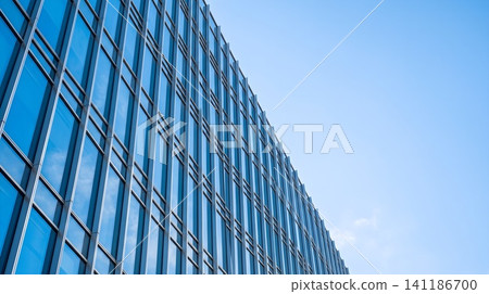 A tall building with a blue sky in the background A tall building with a blue sky in the background 141186700