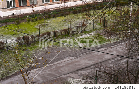 hail remains visible on road and green grass after storm, hail remains visible on road and green grass after storm, 141186813