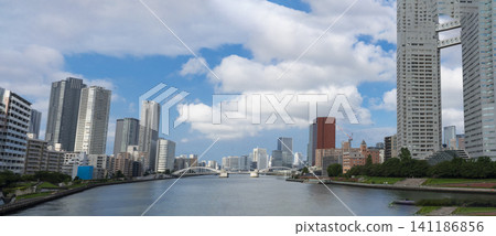 The Sumida River, Kachidoki Bridge, and the urban landscape of Tokyo Bay lined with high-rise condominiums. The Sumida River, Kachidoki Bridge, and the urban landscape of Tokyo Bay lined with high-rise condominiums. 141186856