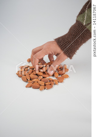 Gathering roasted almonds with care in a cozy setting Gathering roasted almonds with care in a cozy setting 141187067
