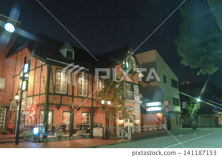 The retro exterior of the now-defunct Tealand Konohana store stands warmly on a street corner at night. The retro exterior of the now-defunct Tealand Konohana store stands warmly on a street corner at night. 141187153