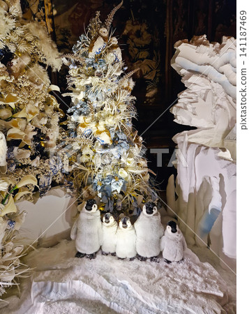 Maincy, France - December 11, 2025: Family of plush penguins on faux snow and winter trees in background. Magical Christmas holiday decor inside the historic Vaux-le-Vicomte Chateau Maincy, France - December 11, 2025: Family of plush penguins on faux snow and winter trees in background. Magical Christmas holiday decor inside the historic Vaux-le-Vicomte Chateau 141187469