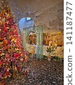 Maincy, France - December 11, 2025: A Christmas decor with a vintage late autumn tree decorated with deep gold leaves set in an orangery room inside the historic Vaux-le-Vicomte Chateau 141187477