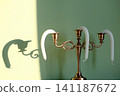 A hot summer concept. A candelabra with candles that melt in the heat. 141187672