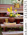 Vintage still life on an old wooden porch with wildflowers and an old book 141187675
