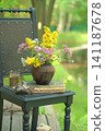 Vintage still life on an old chair with wildflowers and an old book. 141187678