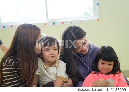The teacher is teaching young children in a class at school. The teacher is teaching young children in a class at school. 141187699