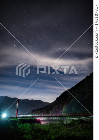 繁星點點，透過覆蓋夜空的雲層縫隙閃耀。 141187817