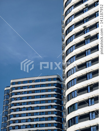 New blue residential skyscrapers with elegant city architecture and bright apartment windows 141187952