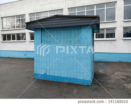 Blue ventilation housing near a Soviet school, highlighting practical engineering solutions and characteristic architectural elements of public institutions Blue ventilation housing near a Soviet school, highlighting practical engineering solutions and characteristic architectural elements of public institutions 141188028