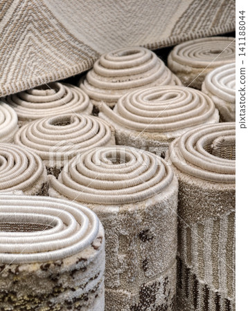 Decorative floor carpets in warm tones arranged in a megastore presenting elegant textures and stylish home decoration concepts Decorative floor carpets in warm tones arranged in a megastore presenting elegant textures and stylish home decoration concepts 141188044