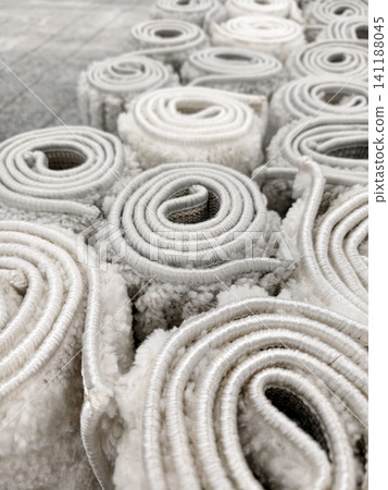 Luxury fluffy decorative carpets in light and gray tones displayed in a mall offering elegant and cozy flooring solutions Luxury fluffy decorative carpets in light and gray tones displayed in a mall offering elegant and cozy flooring solutions 141188045