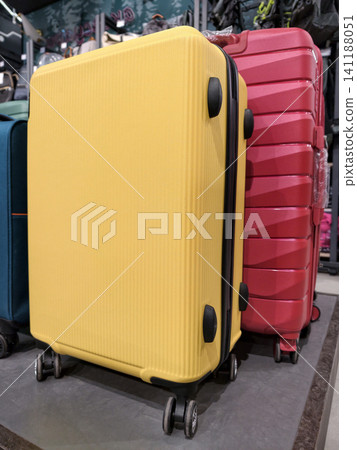 Large luggage pieces displayed in an aisle of a supermarket for easy access Large luggage pieces displayed in an aisle of a supermarket for easy access 141188051