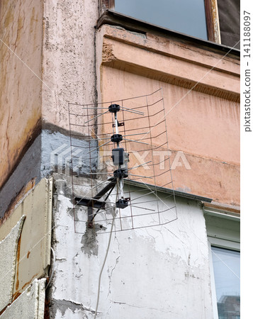 Vintage outdoor television and radio antenna fixed to balcony of high-rise residential block Vintage outdoor television and radio antenna fixed to balcony of high-rise residential block 141188097