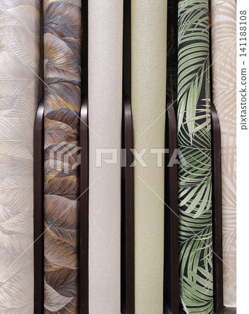 Modern wallpaper rolls displayed on shelves in a home improvement store, ready to be chosen for various renovation projects Modern wallpaper rolls displayed on shelves in a home improvement store, ready to be chosen for various renovation projects 141188108