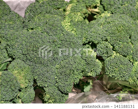 A close-up shot of green broccoli in a box at a grocery store, highlighting fresh vegetables for healthy living 141188131