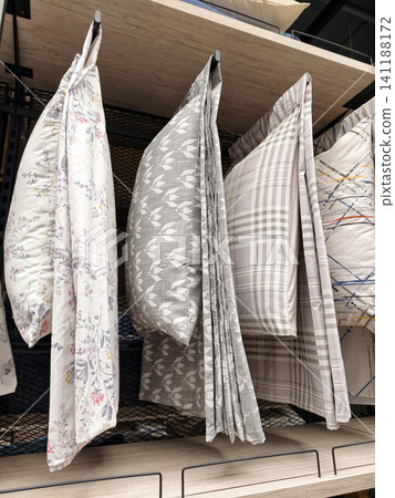 Soft bedding pillows displayed on shelves in urban home outlet Soft bedding pillows displayed on shelves in urban home outlet 141188172