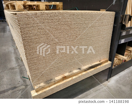 Oriented Strand Board or OSB, structural wood board for wall construction and other wood product manufacturing kept in industrial warehouse 141188198