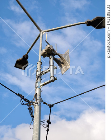 A loud siren for air raids, typically mounted on poles, to warn civilians of incoming missile or bomb threats A loud siren for air raids, typically mounted on poles, to warn civilians of incoming missile or bomb threats 141188233